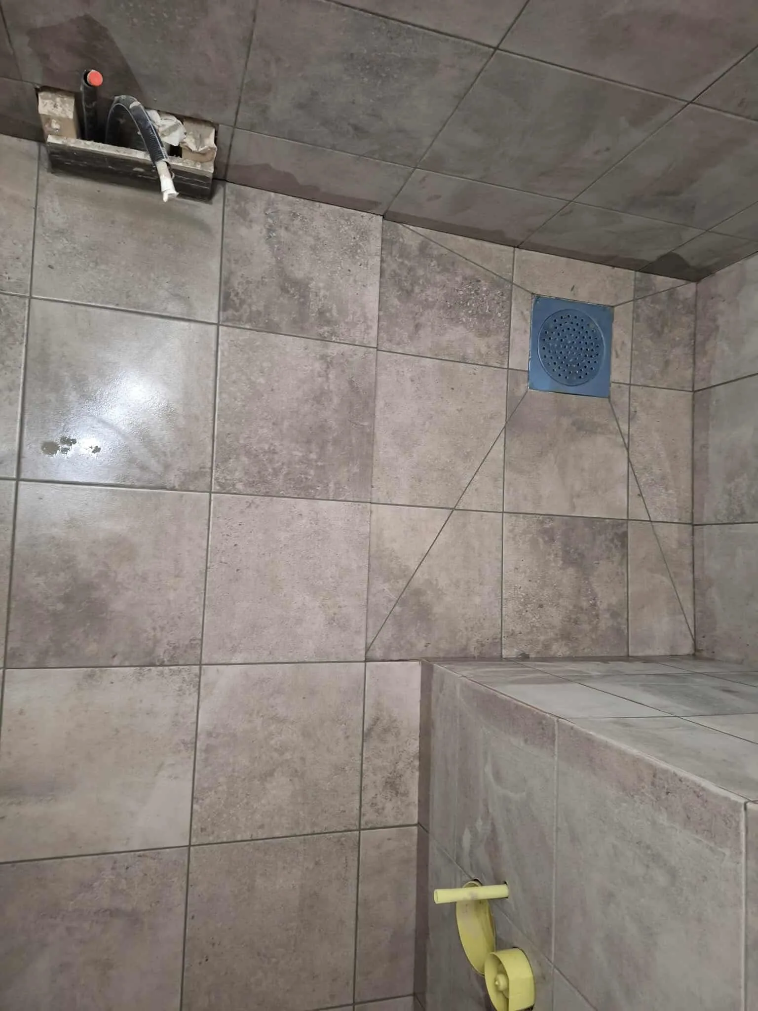 Bathroom renovation with large gray ceramic tiles