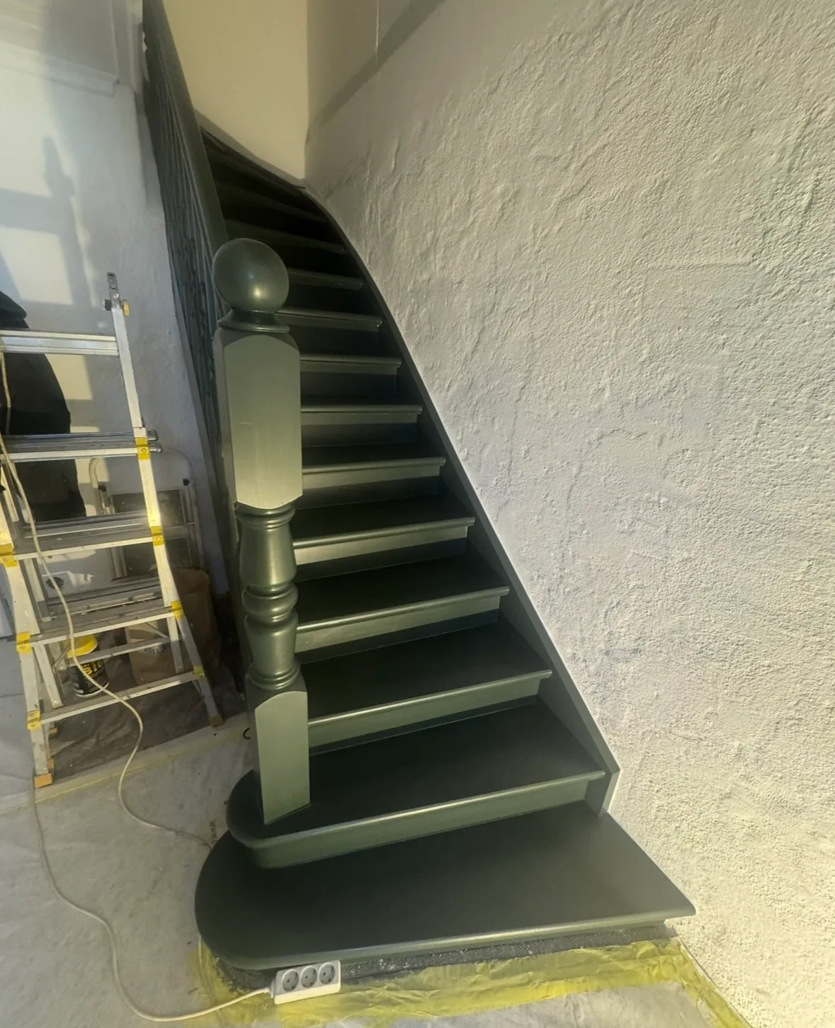 Modern black staircase with green accent steps